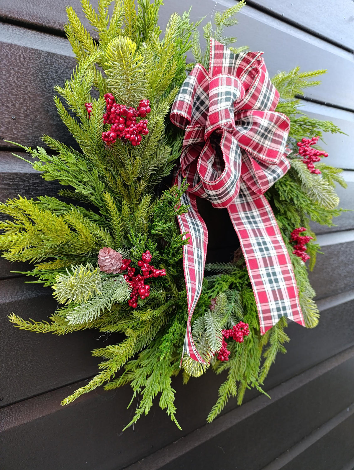 Norfolk Pine and Cedar Realistic Greenery Wreath with Red Berries and Feature Plaid Tartan Bow